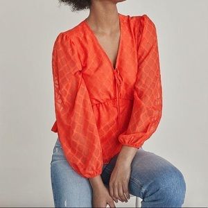 Orange peplum long sleeve top